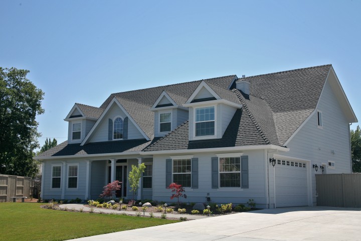 L and L Roofing crew installing new shingles on residential home in Davis California